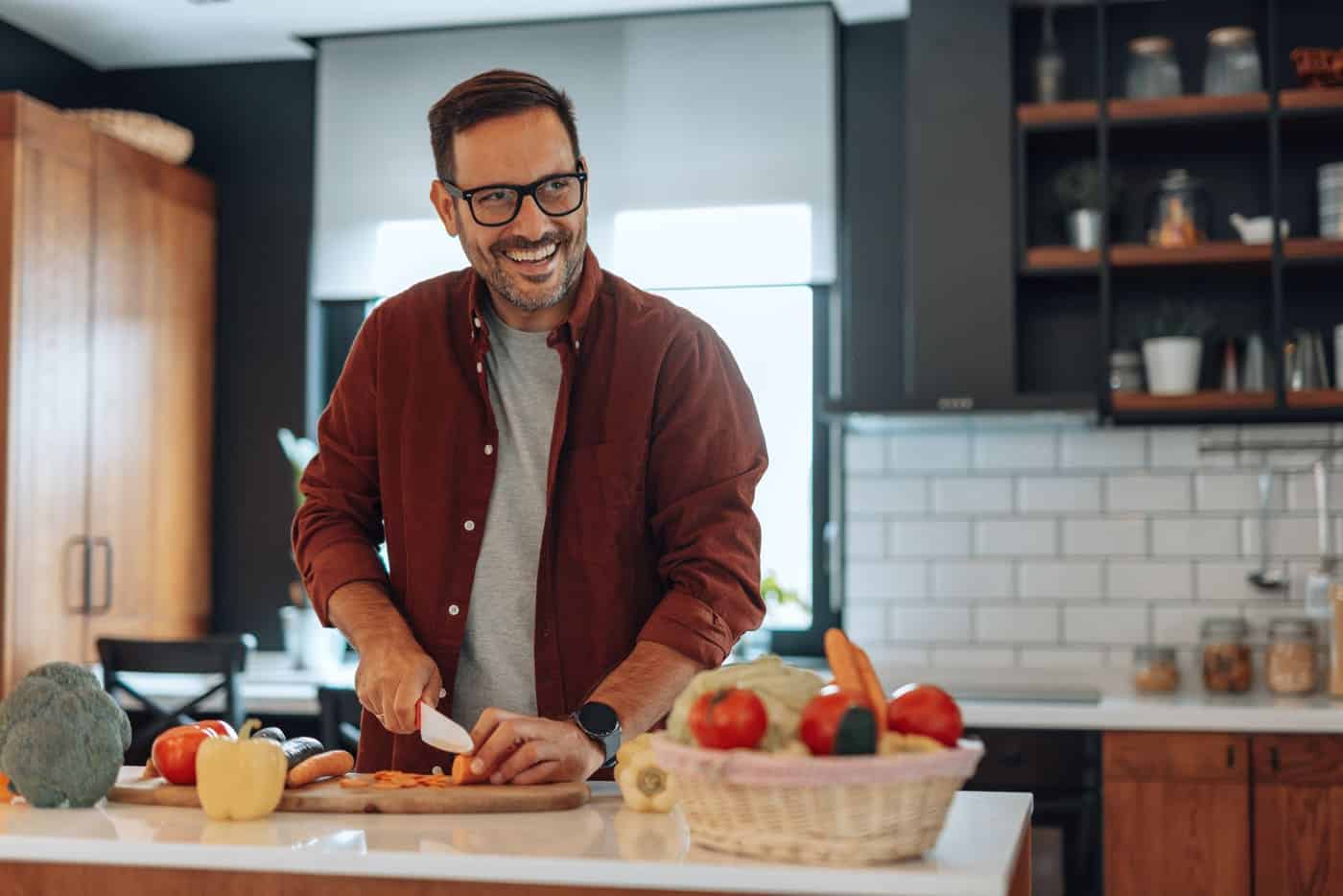 Man Happy and Healthy in the kitchen cooking food